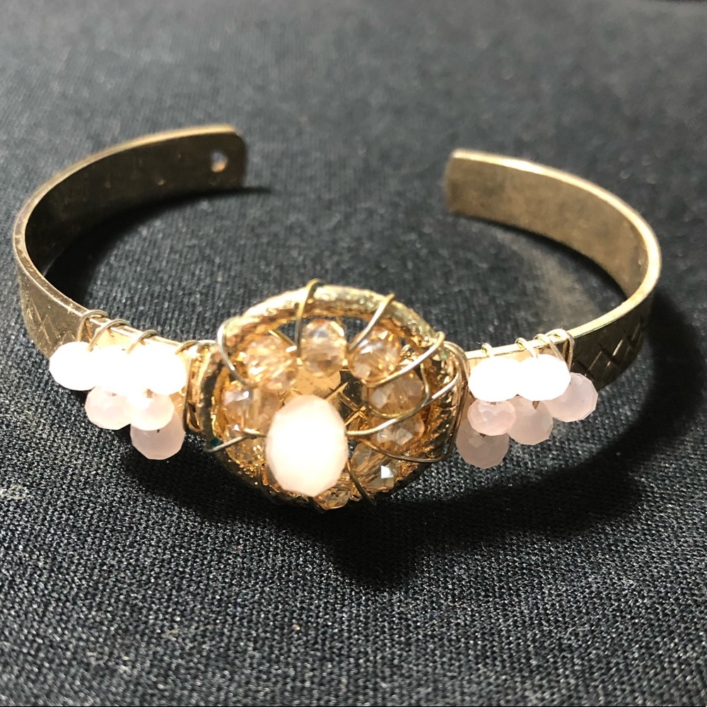 Gold bracelet with light pink stones